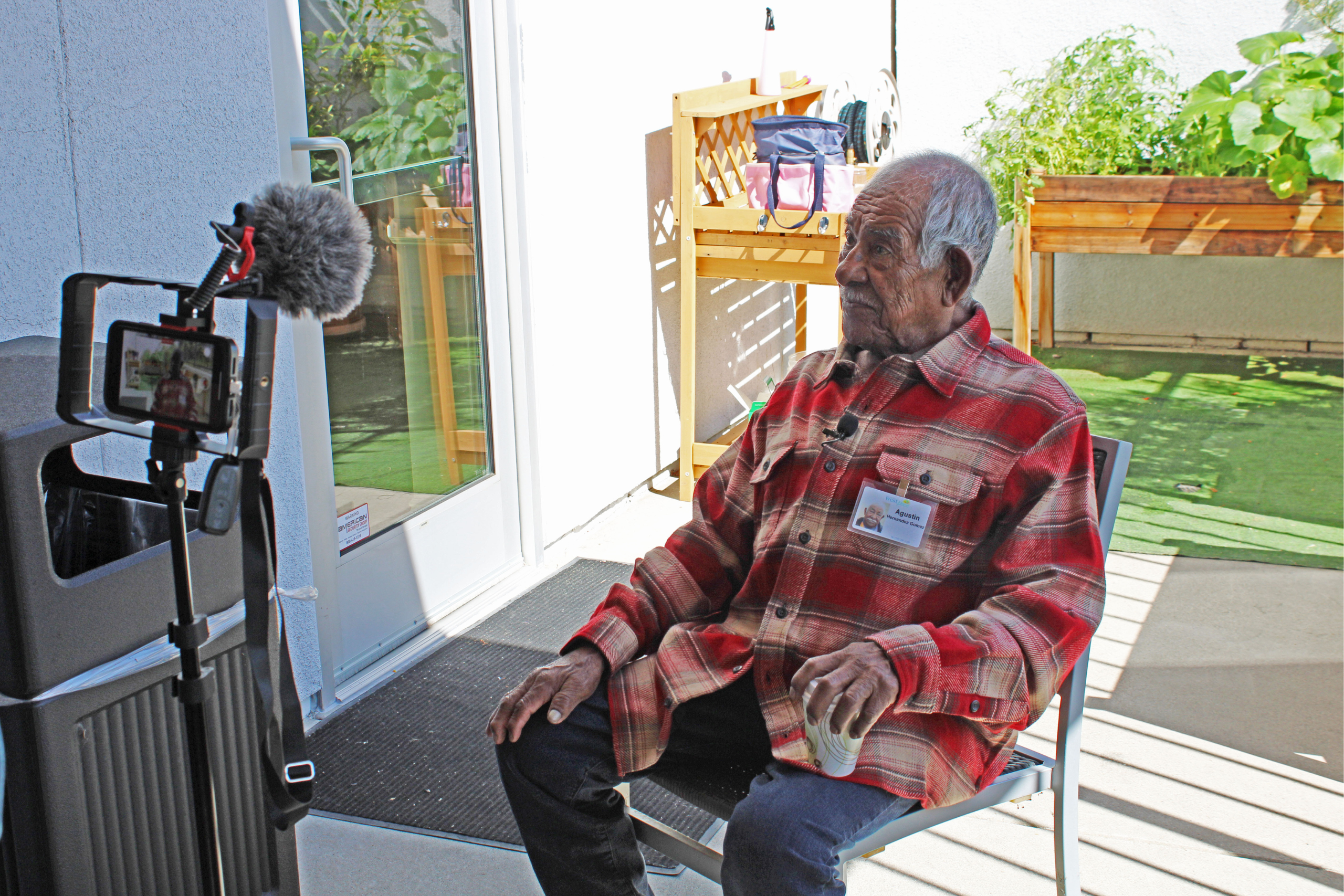 Participant sitting outside being interviewed