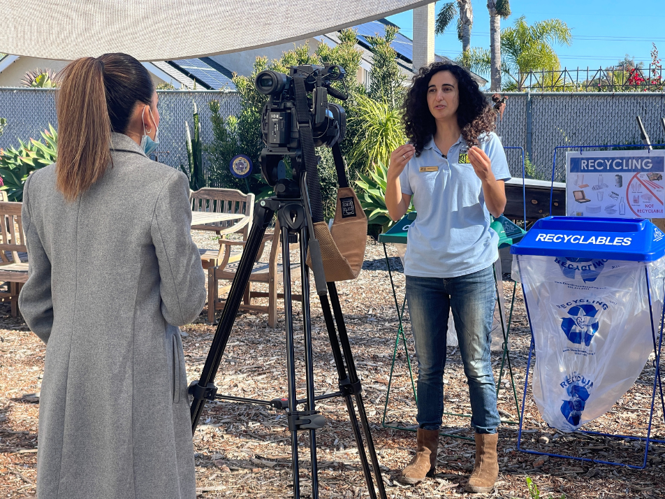 Jackie Bookstein, environmental educator and rain barrel lead at Solana Center for Environmental Innovation being interviewed by Univision San Diego reporter, Jasmin Sherif on proper waste disposal at large events.